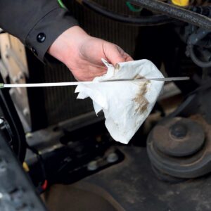 Checking the oil after oil change. Part of the service included with Genuine Care service contracts.