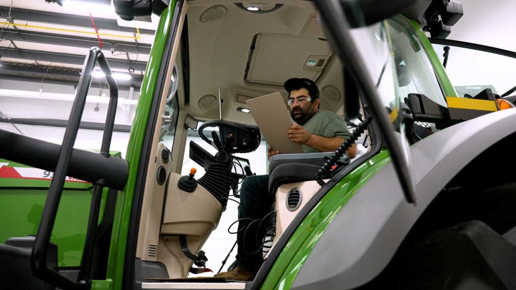 Cody reads fuse panel in Fendt tractor