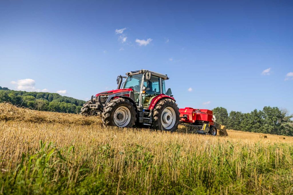 Massey Ferguson tractor pulling a square baler through a hay field on a sunny day, demonstrating reliable baling performance for mixed and livestock operations in southern Alberta.