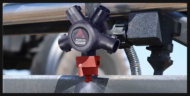 AGCO precision agriculture sprayer nozzle applying liquid during field operation, supported by Hanlon Ag Centre precision ag solutions in southern Alberta. Demonstrating AGCO parts available at Hanlon Ag Centre.