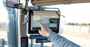 Close-up of Trimble GFX display running CenterPoint RTX guidance system for precise field operations on a modern farm tractor
