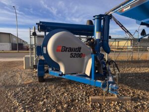 Brandt 5200EX grain vac on farm yard in Southern Alberta, supporting efficient grain handling.